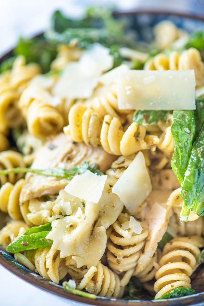 Close up of pesto pasta salad in a blue bowl