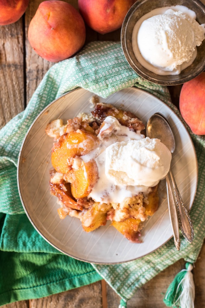 Peach cobbler cake with a scoop of ice cream