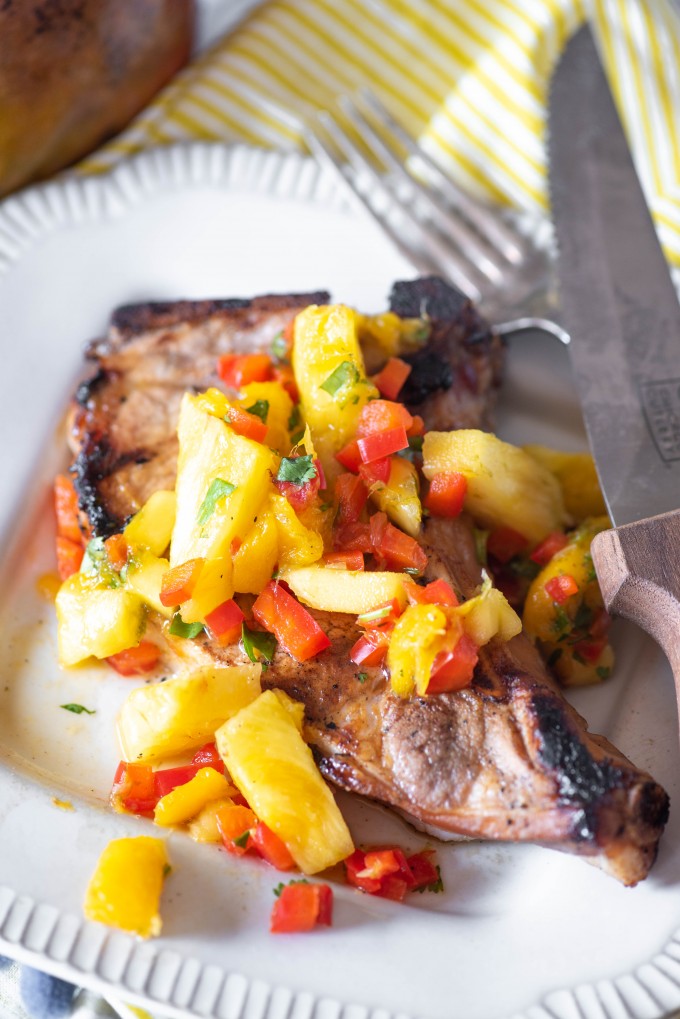 Grilled pork chops with tropical salsa on a plate