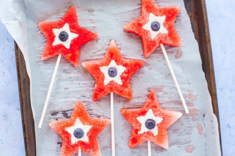 read white and blue watermelon pops on a tray