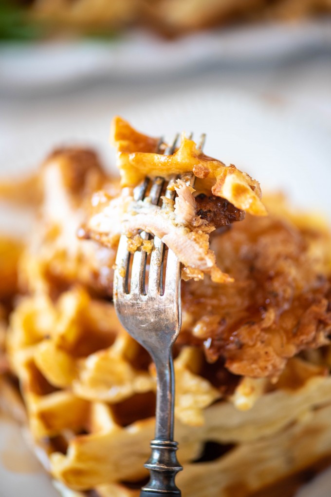 Cut bite of chicken and waffles