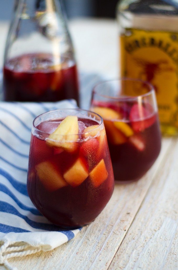 Two glasses of fireball sangria on a blue and white napkin