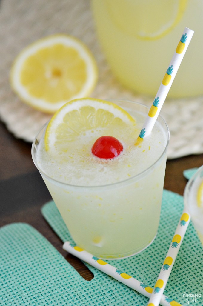 A glass of frozen lemonade with a cherry on top