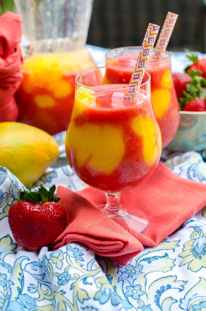 Glass of mango strawberry daiquiri on a red napkin