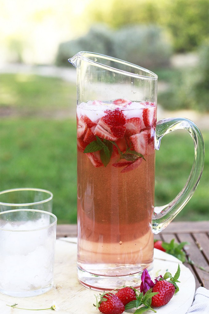 Tall pitcher of rose sangria with two glasses