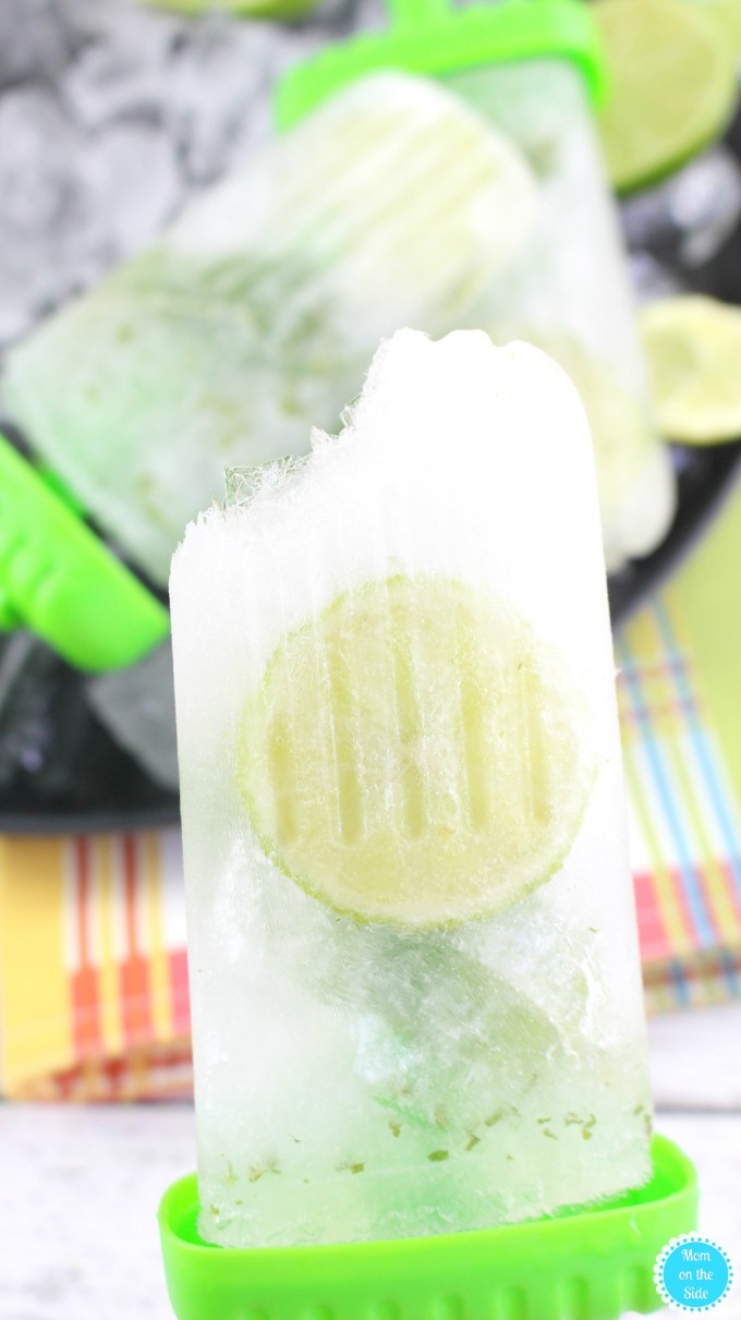 A mojito popsicle with a bit taken out