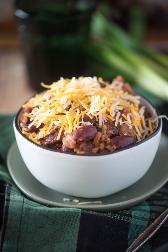 Instant pot chili topped with cheese in a white bowl