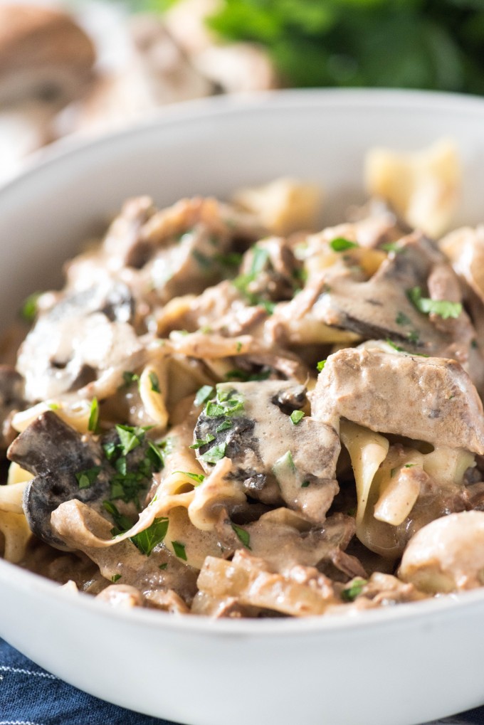 Slow cooker beef stroganoff in a white bowl