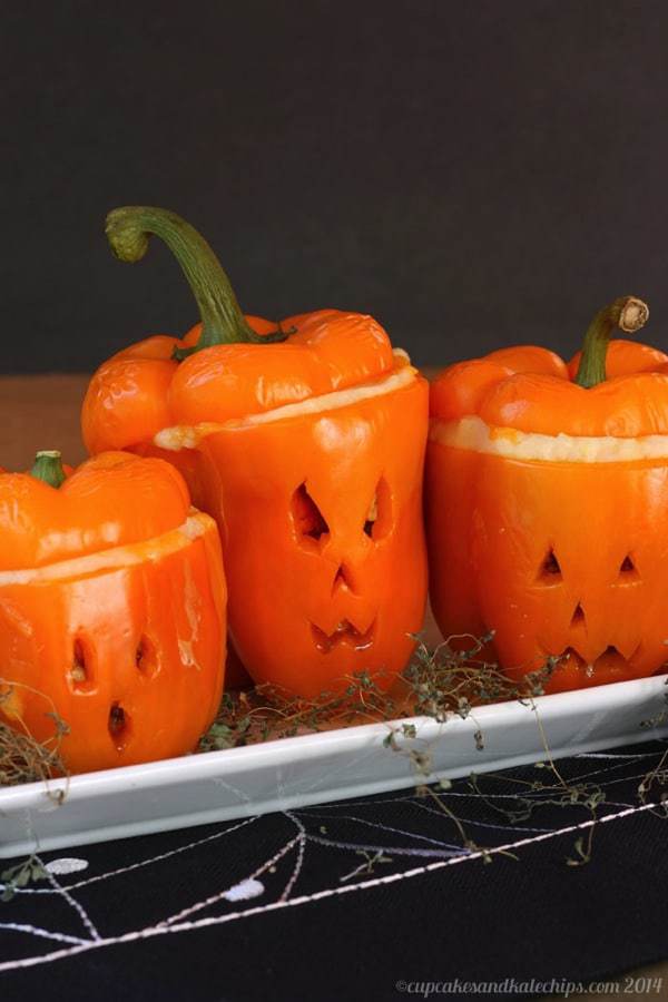 Three jack o lantern shepherd pies on a tray