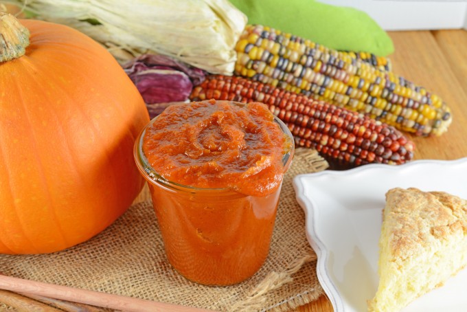 Jar of pumpkin butter with corn and a pumpkin