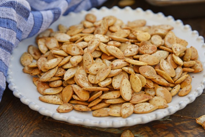 Roasted pumpkin seeds on a white plate