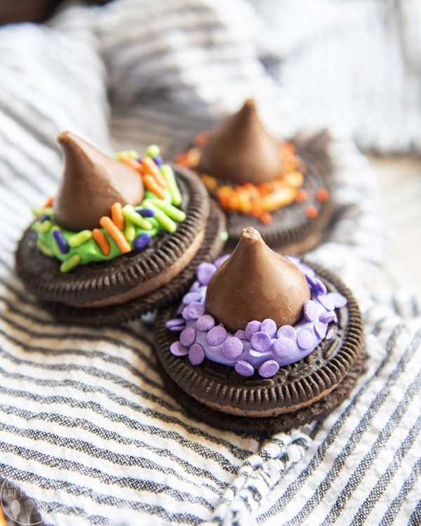 Three witch hat cookies on a kitchen towel
