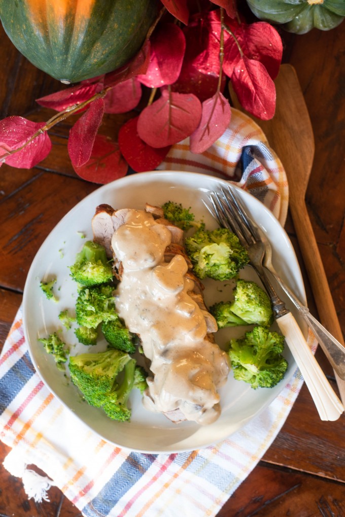 Instant Pot pork tenderloin on a white plate with broccoli