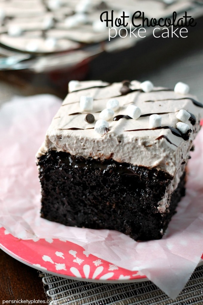 Slice of hot chocolate poke cake on parchment paper - christmas desserts