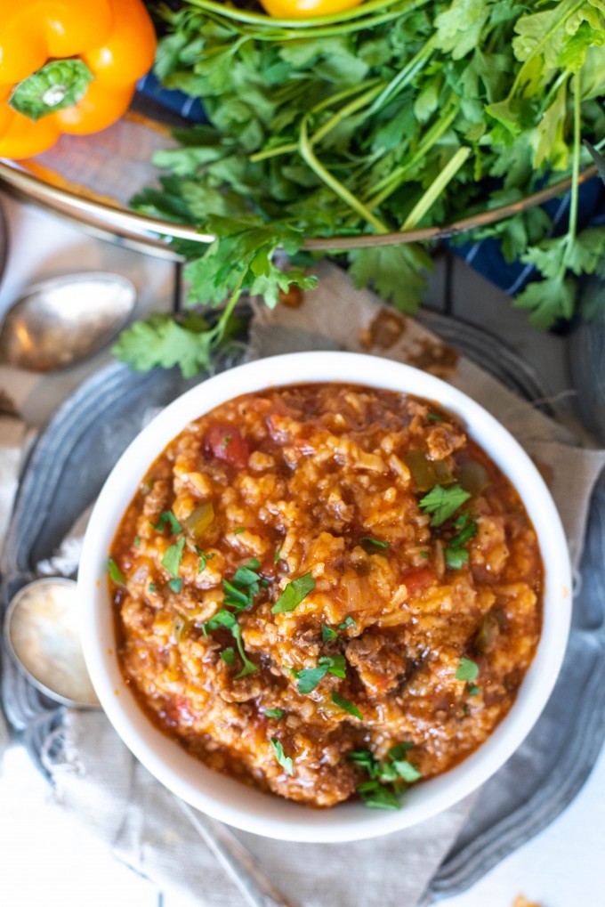 Easy stuffed Pepper soup in a white bowl topped with parsley 