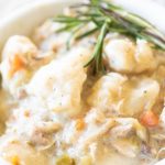 Close up of best instant pot chicken and dumplings in a white bowl
