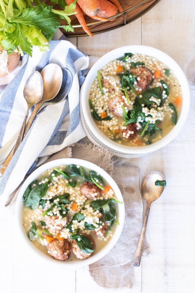 This Instant Pot Italian Wedding Soup is one of the best soup recipes! Made super easy with frozen meatballs, it's a great way to get dinner on the table fast! #gogogogourmet #instantpotitalianweddingsoup #instantpotsouprecipes #easyinstantpotrecipes Overhead view of two bowls of instant pot italian wedding soup