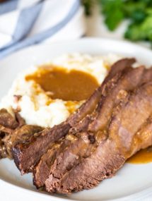 Best instant pot brisket on a white plate with mashed potatoes