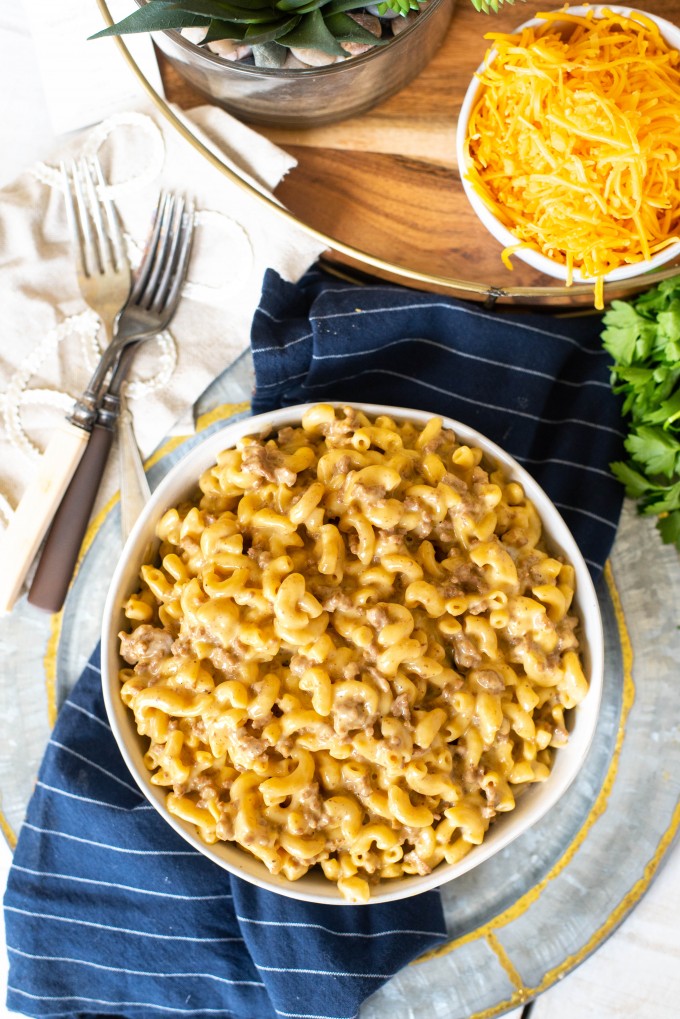 Overhead view of a bowl of cheeseburger mac on a blue towel