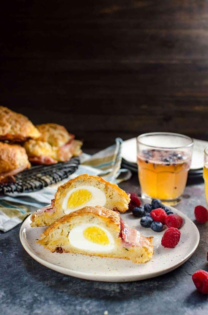 Boiled egg recipes - breakfast croissant cut in half on a white plate with berries