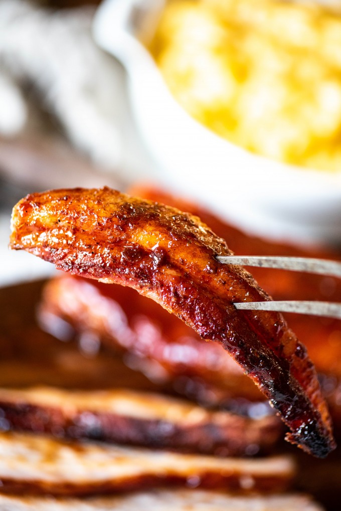 Slice of BBQ Smoked Pork Belly on fork