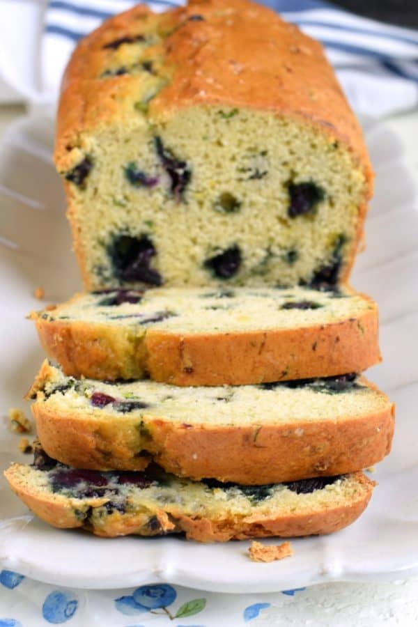 Blueberry zucchini bread sliced on a white plate