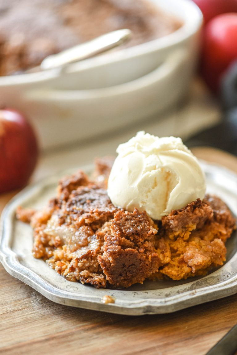 Apple Pumpkin Dump Cake topped with ice cream on a plate