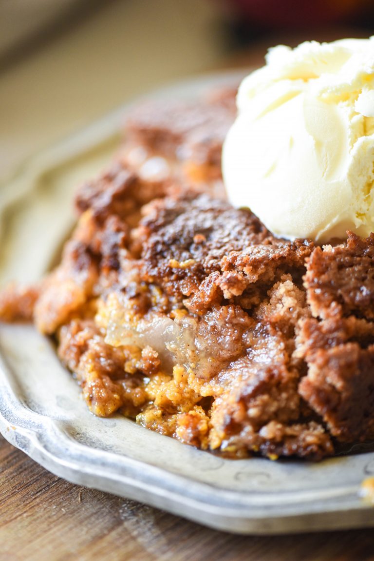 Close up of Apple Pumpkin Dump Cake with a scoop of ice cream on top