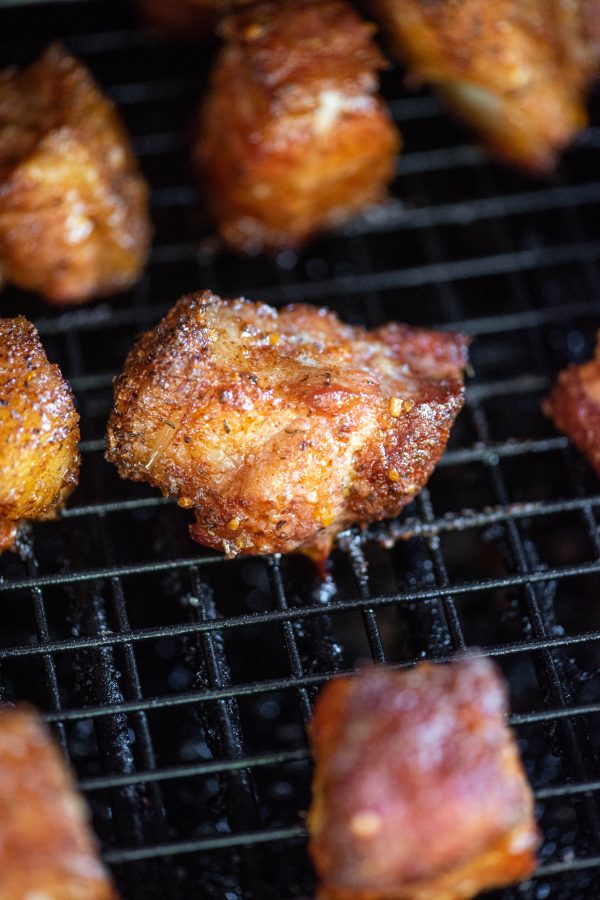 Close up of pork belly burnt ends on a cooling rack