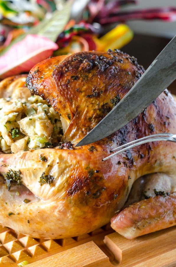 Knife cutting into Herb Roasted Turkey