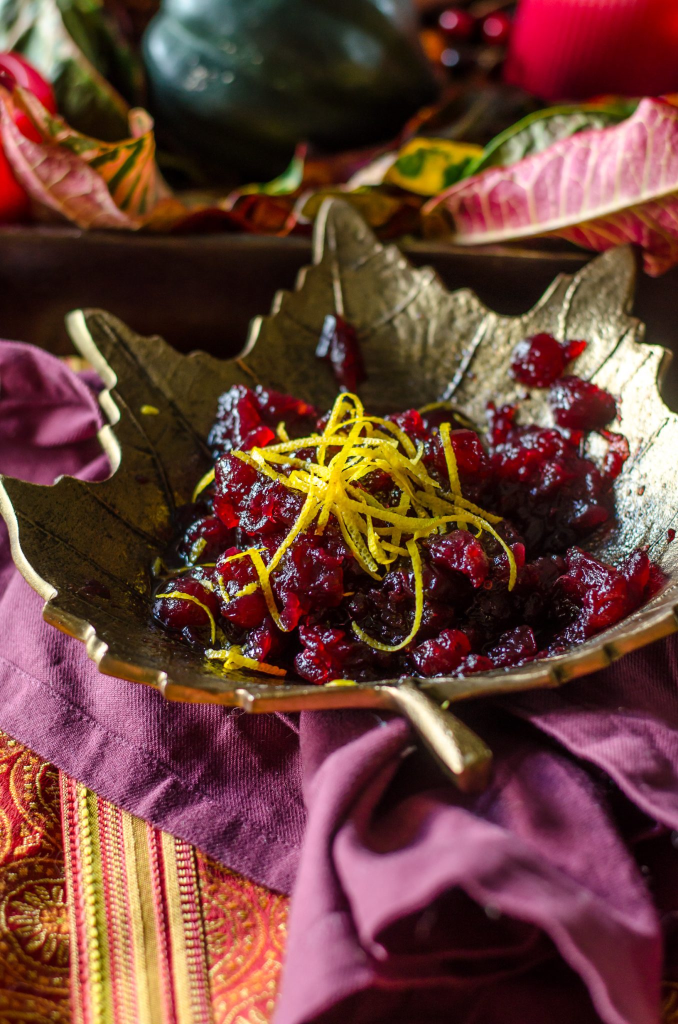 Cranberry sauce topped with orange zest in a leaf bowl