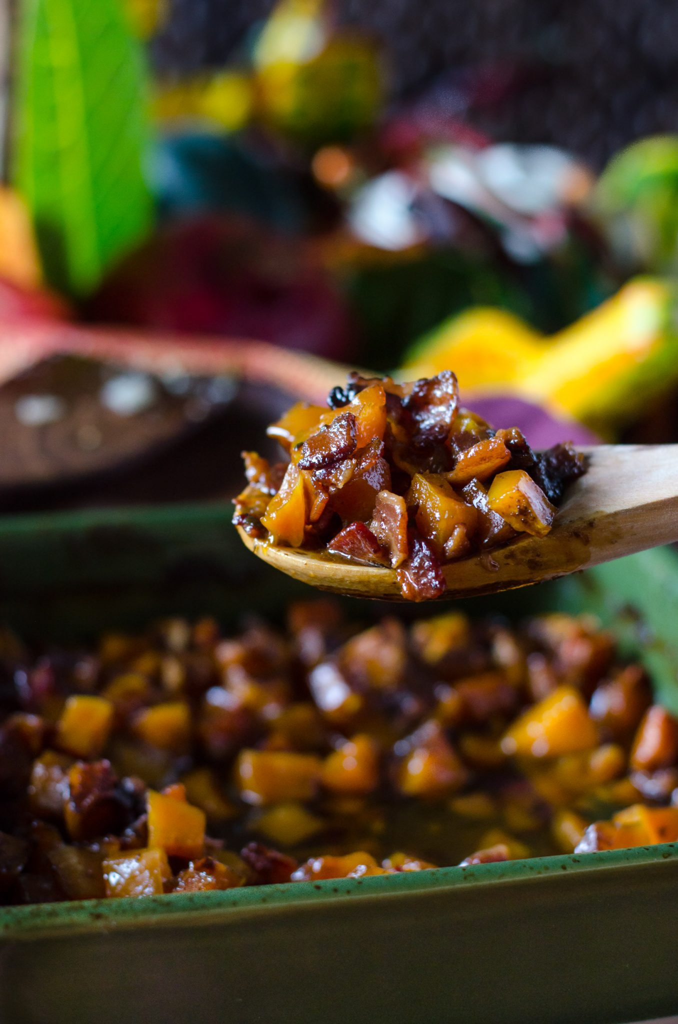 Close up of bourbon bacon brown sugar butternut squash on a wooden spoon