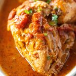 Close up of chicken cacciatore in a white baking dish