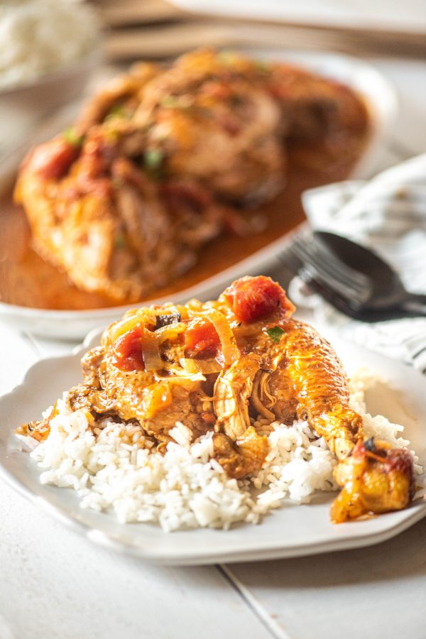 Instant Pot Chicken over rice on a white plate