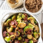 Overhead view of stovetop brussels sprouts in a white bowl