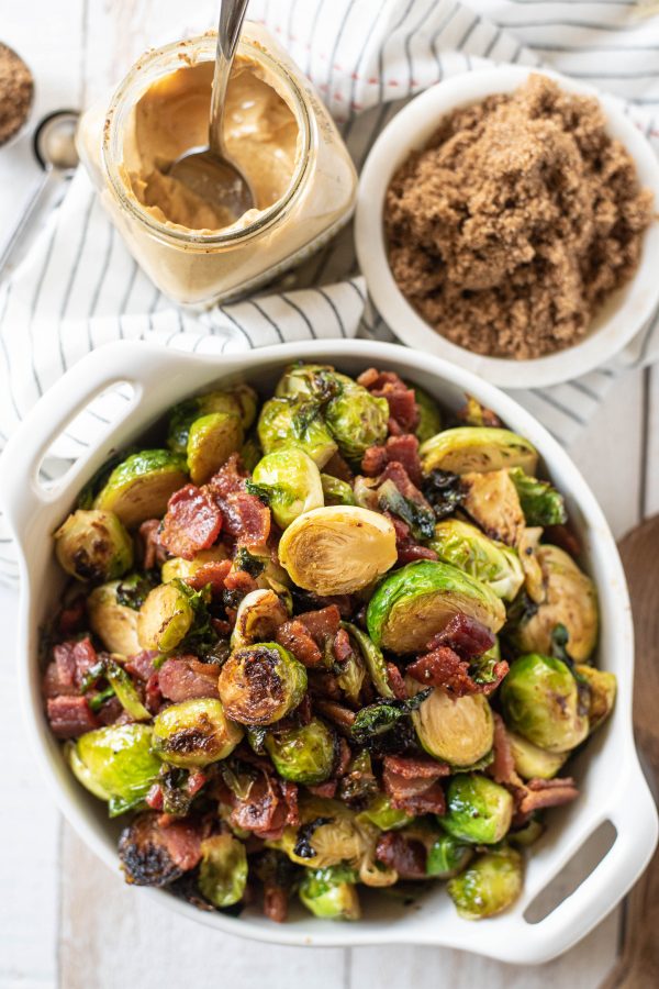 Overhead view of stovetop brussels sprouts in a white bowl